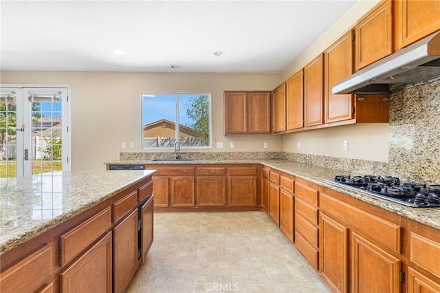 27674 Blue Topaz Dr, Menifee, CA 92585 - kitchen featuring a sink, brown cabinets, decorative backsplash, gas stovetop, and under cabinet range hood