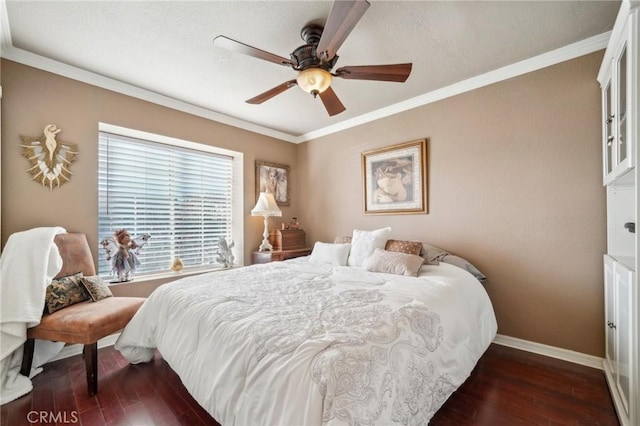 bedroom featuring a ceiling fan, baseboards, ornamental molding, and dark wood finished floors