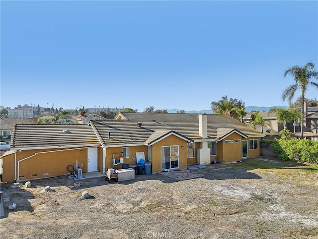 view of front of property with a tile roof and stucco siding