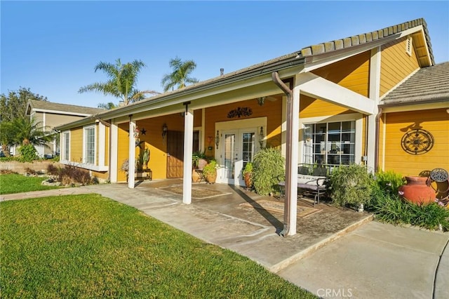 back of house with a yard and french doors