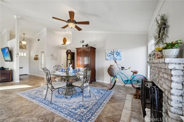 dining space with a ceiling fan, lofted ceiling, crown molding, and baseboards