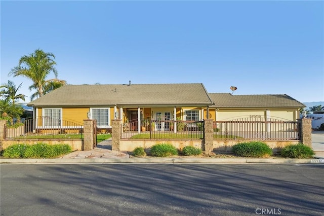 ranch-style home with stucco siding, concrete driveway, a garage, and a fenced front yard