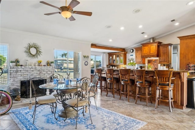 dining space with a healthy amount of sunlight and ornamental molding