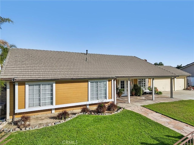 view of front of property with concrete driveway, a garage, and a front yard