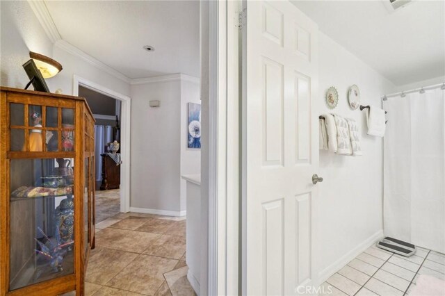 full bathroom with crown molding, tile patterned floors, baseboards, and a shower with curtain