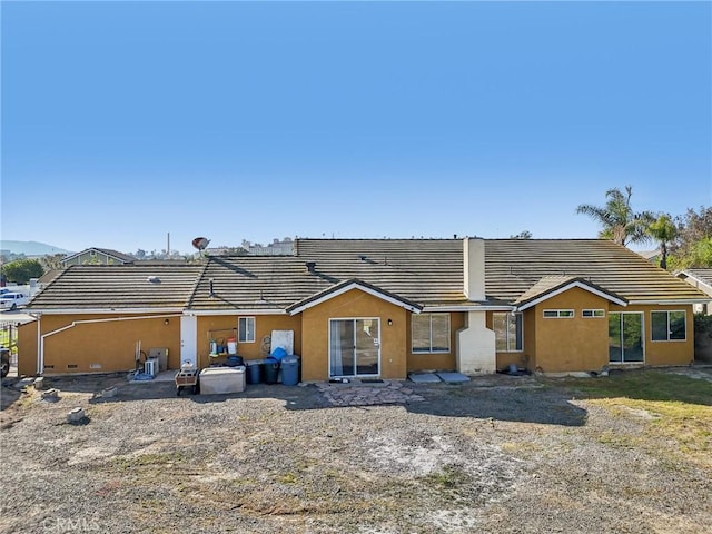 view of front facade featuring a tiled roof and stucco siding