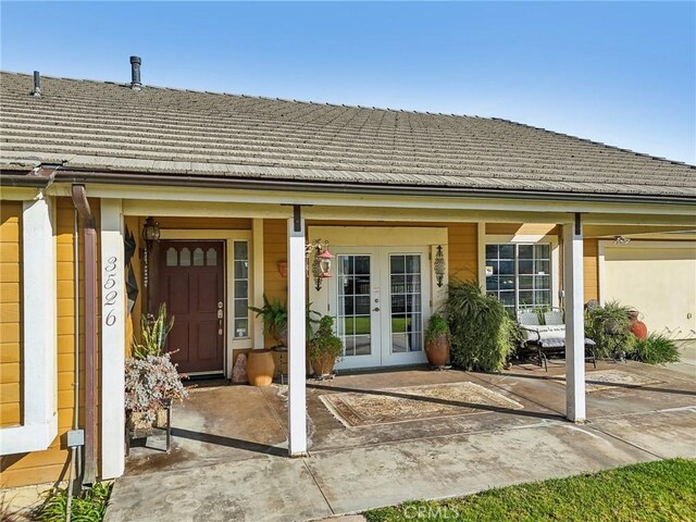 property entrance with a porch and french doors