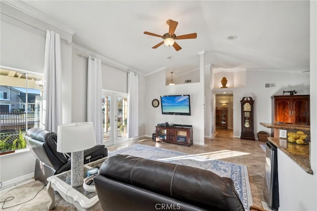 living room with a ceiling fan, crown molding, baseboards, lofted ceiling, and visible vents