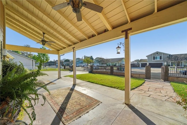 view of patio / terrace with fence, a ceiling fan, and a residential view