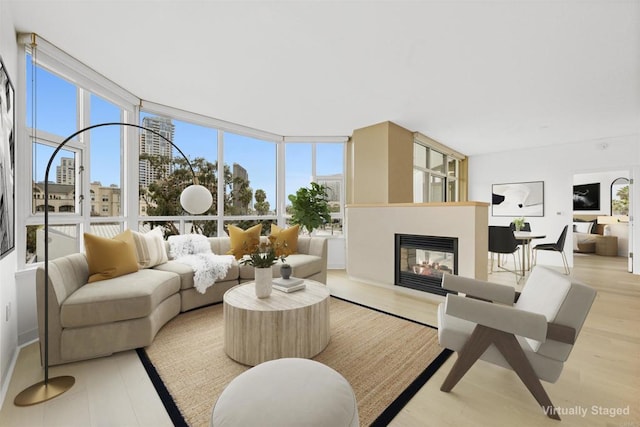 700 W Harbor Dr Unit 402, San Diego, CA 92101 - living area featuring light wood-style flooring, healthy amount of natural light, and a glass covered fireplace