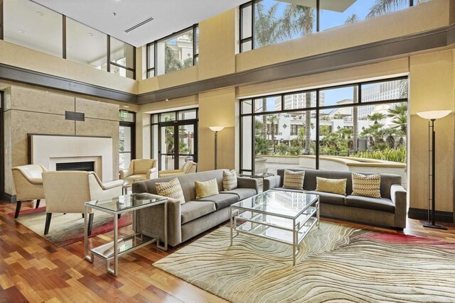 700 W Harbor Dr Unit 402, San Diego, CA 92101 - living area featuring wood finished floors, a fireplace, and a towering ceiling