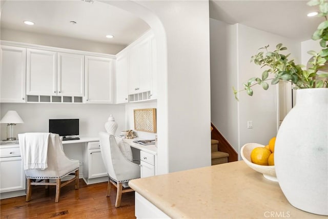 interior space with white cabinets, light countertops, and built in desk