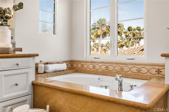 full bathroom with a garden tub and vanity