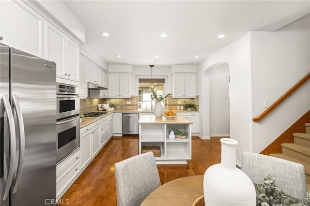 kitchen with open shelves, decorative backsplash, white cabinetry, light countertops, and appliances with stainless steel finishes