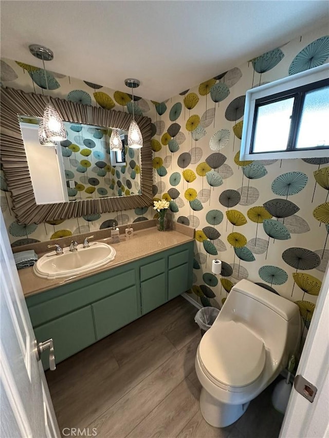 1007 S Catalina Ave Unit 212, Redondo Beach, CA 90277 - bathroom featuring wood finished floors, wallpapered walls, vanity, and toilet