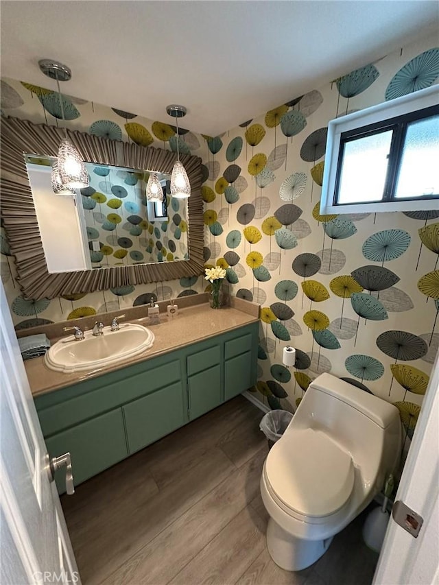 1007 S Catalina Ave Unit 212, Redondo Beach, CA 90277 - bathroom featuring wood finished floors, vanity, wallpapered walls, toilet, and a shower