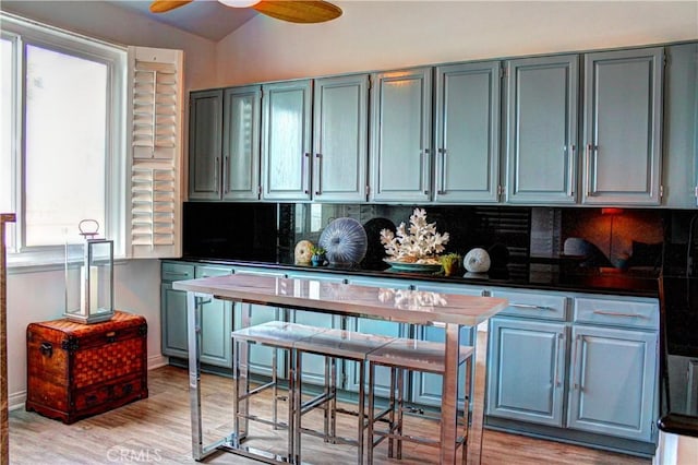 1007 S Catalina Ave Unit 212, Redondo Beach, CA 90277 - kitchen with tasteful backsplash, dark countertops, gray cabinets, light wood-type flooring, and a ceiling fan