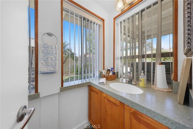 bathroom featuring a healthy amount of sunlight and vanity