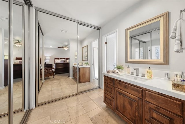 ensuite bathroom with visible vents, vanity, ensuite bathroom, ceiling fan, and tile patterned floors