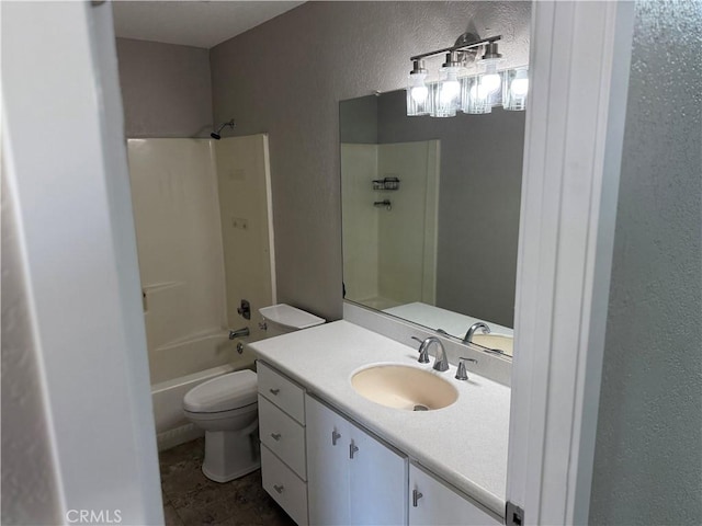 bathroom with bathing tub / shower combination, a textured wall, vanity, and toilet