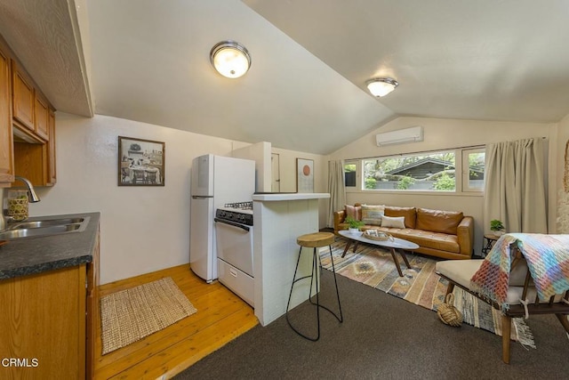kitchen with white gas range, a sink, brown cabinetry, light wood-style floors, and a wall unit AC