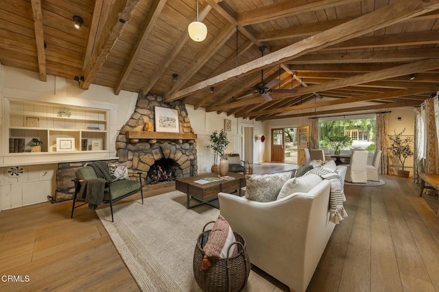 living area with wood ceiling, wood-type flooring, a ceiling fan, and lofted ceiling with beams