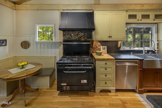 kitchen with range with gas cooktop, dishwasher, light wood-type flooring, decorative backsplash, and custom exhaust hood