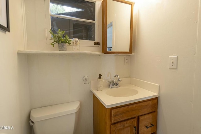 bathroom featuring toilet and vanity