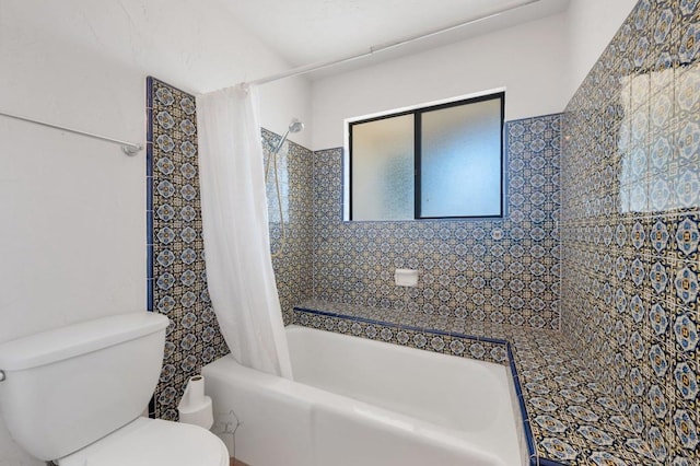 full bath with toilet and shower / bath combo with shower curtain