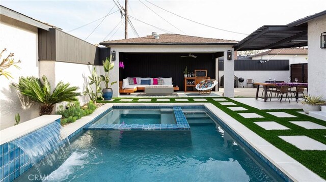 view of swimming pool featuring fence, an outbuilding, a patio, an outdoor hangout area, and a pool with connected hot tub