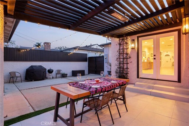 view of patio featuring french doors, a pergola, fence, area for grilling, and outdoor dining area