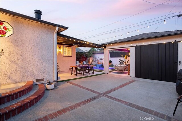 patio terrace at dusk with outdoor dining area