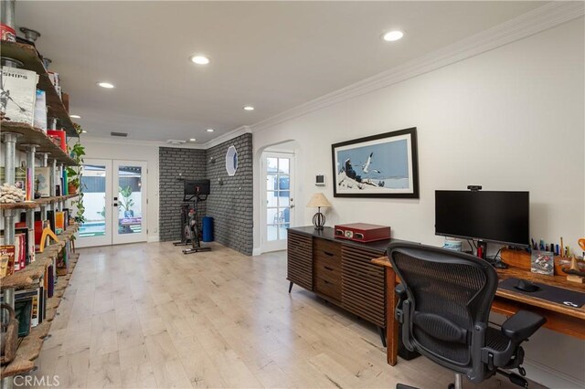 office area featuring plenty of natural light, light wood-style flooring, ornamental molding, and french doors