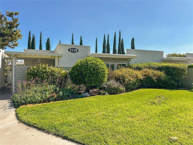 2119 Via Puerta Unit U, Laguna Woods, CA 92637 - view of front of home with a front lawn and stucco siding