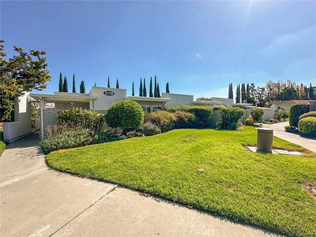 2119 Via Puerta Unit U, Laguna Woods, CA 92637 - view of front of home featuring a front lawn and stucco siding