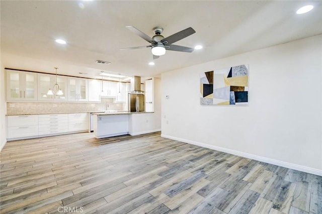 2119 Via Puerta Unit U, Laguna Woods, CA 92637 - unfurnished living room with a ceiling fan, light wood-style floors, baseboards, visible vents, and recessed lighting