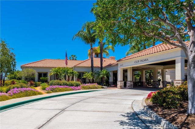 view of building exterior featuring driveway and a carport