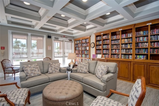 sitting room featuring ornamental molding, beamed ceiling, recessed lighting, bookshelves, and coffered ceiling