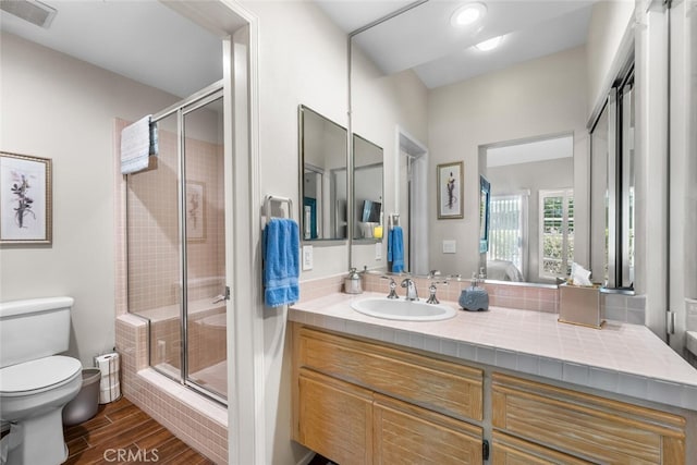 ensuite bathroom featuring toilet, visible vents, a shower stall, and ensuite bathroom