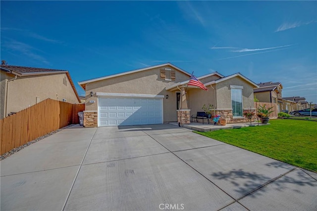 718 Marybelle Dr, Merced, CA 95348 - ranch-style home featuring concrete driveway, fence, stone siding, and a garage