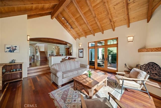 living room featuring high vaulted ceiling, wood finished floors, arched walkways, wooden ceiling, and beam ceiling