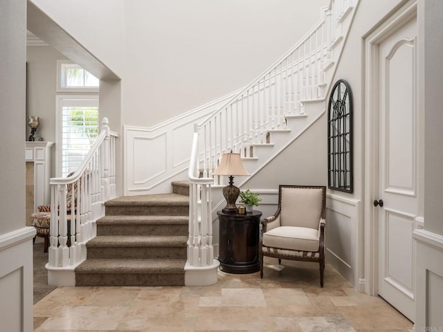 7076 Heron Cir, Carlsbad, CA 92011 - staircase featuring a decorative wall and a wainscoted wall