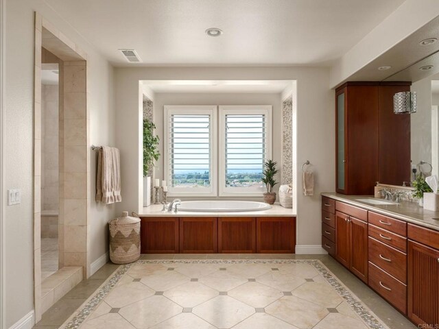 7076 Heron Cir, Carlsbad, CA 92011 - full bathroom with a garden tub, vanity, baseboards, and tile patterned floors