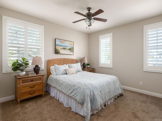 7076 Heron Cir, Carlsbad, CA 92011 - carpeted bedroom with multiple windows, baseboards, and ceiling fan