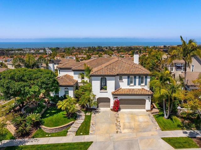 7076 Heron Cir, Carlsbad, CA 92011 - mediterranean / spanish-style house featuring a tiled roof, stucco siding, a garage, driveway, and a chimney