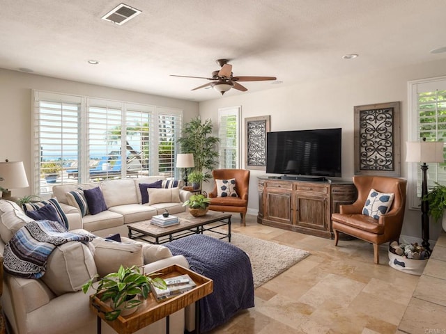7076 Heron Cir, Carlsbad, CA 92011 - living room with a ceiling fan, healthy amount of natural light, light stone finish floors, and recessed lighting
