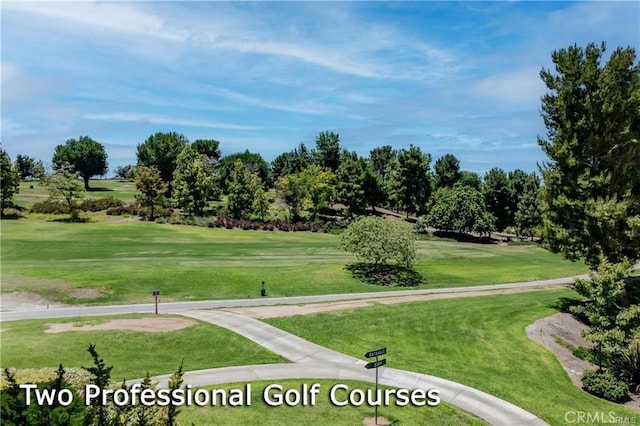 view of community with a lawn and view of golf course