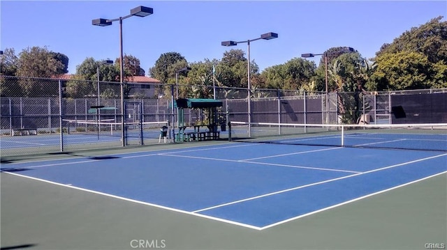 view of sport court featuring fence