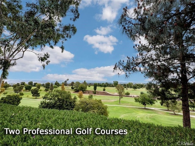view of community featuring a yard and view of golf course