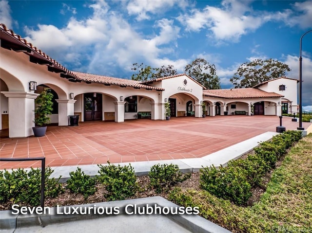mediterranean / spanish-style house with a tile roof and stucco siding